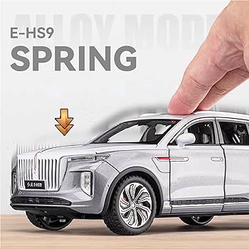 Model car of a luxury vehicle with a hand interacting with it, set against a blurred background.