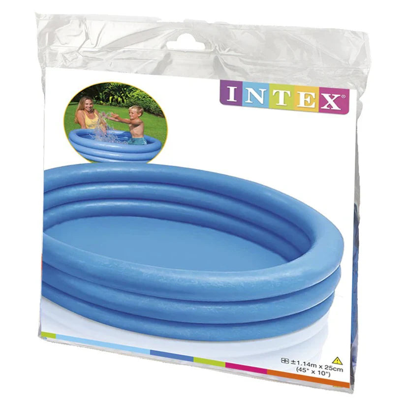 Children playing in a blue inflatable pool with a woman on a grassy lawn.