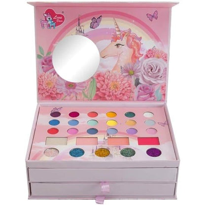 Makeup set with unicorn design on a pink background