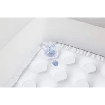 White baby blanket with ruffles and a small blue toy on a white background