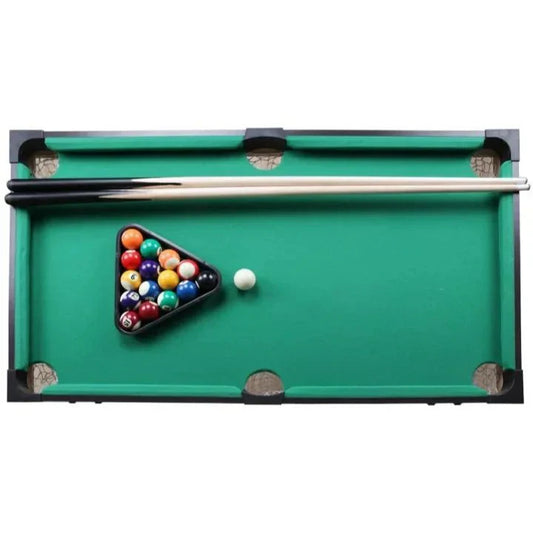 Miniature pool table with balls and a cue on a white background