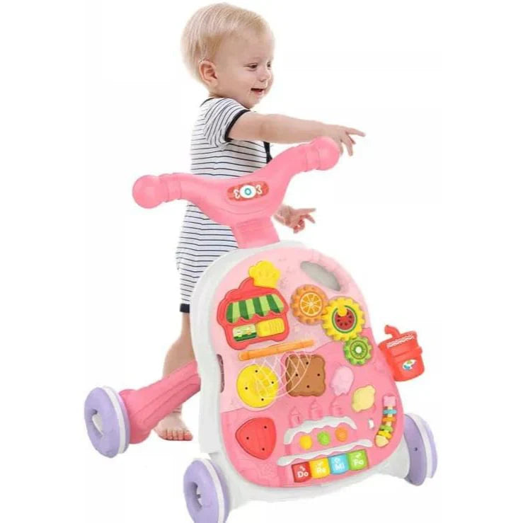 Child playing with a pink toy walker on a white background
