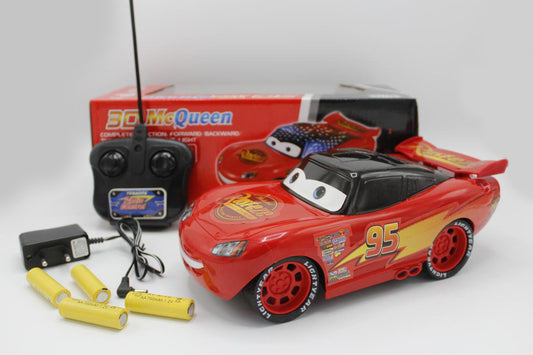 Red toy car with remote control and batteries on a white background