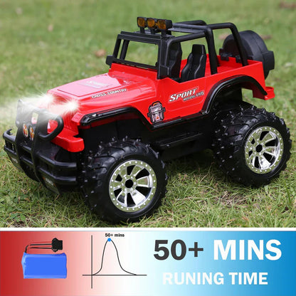 Red toy jeep with black roof on grass, showing battery life indicator.