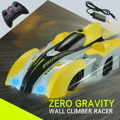Yellow and black wall climber racer with remote control and power adapter on a wooden surface.